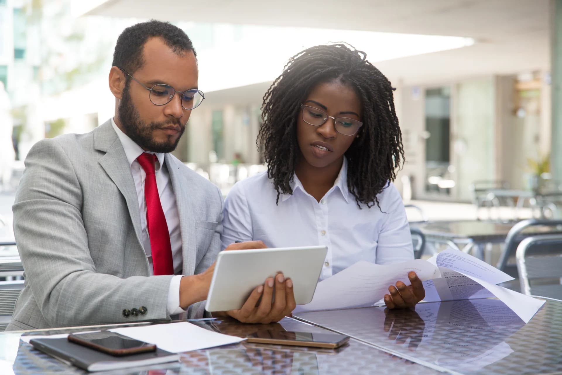 Loan officers reviewing reports on a tablet